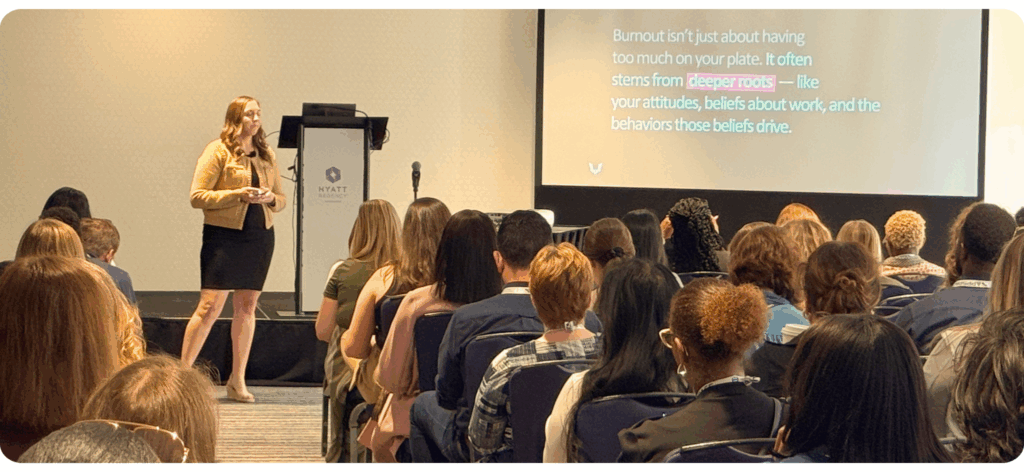 Kelsey Buckholtz presenting on stage