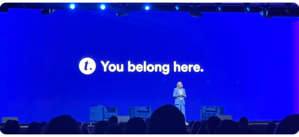 Photo of Transform Conference stage. "You belong here." shows in big letters on the presentation screen